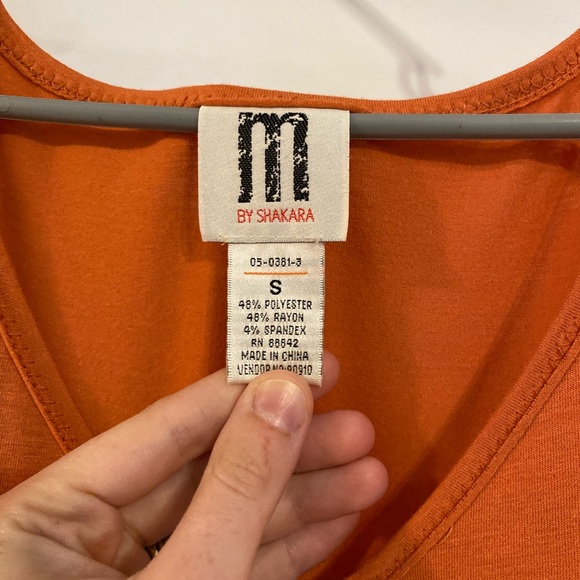 Orange Knee Length Dress with puff sleeves. Beaded detail along the bottom. - Picture 3 of 3